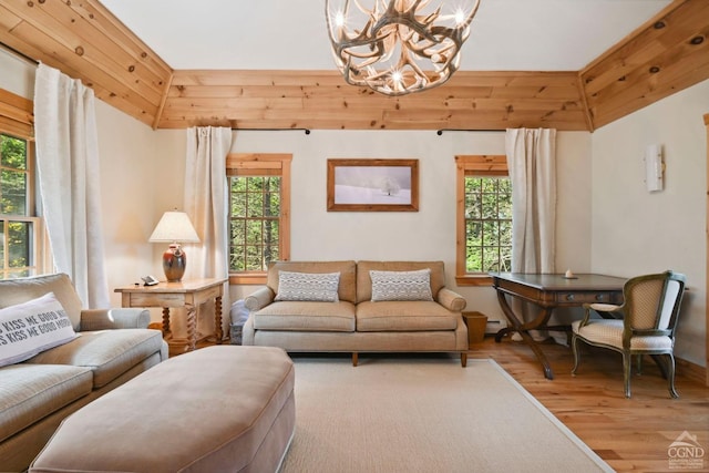 living room with hardwood / wood-style floors and an inviting chandelier