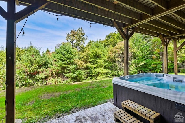 exterior space with a hot tub and a deck