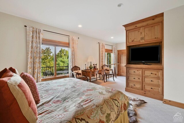 bedroom with light carpet and multiple windows