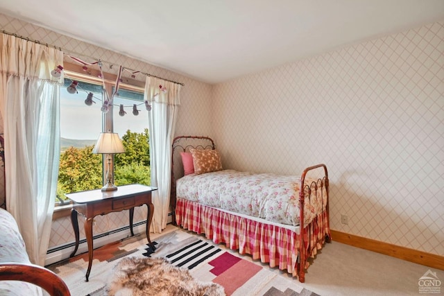 bedroom with multiple windows and a baseboard radiator