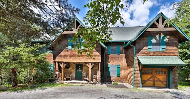 view of front of property featuring covered porch and a garage