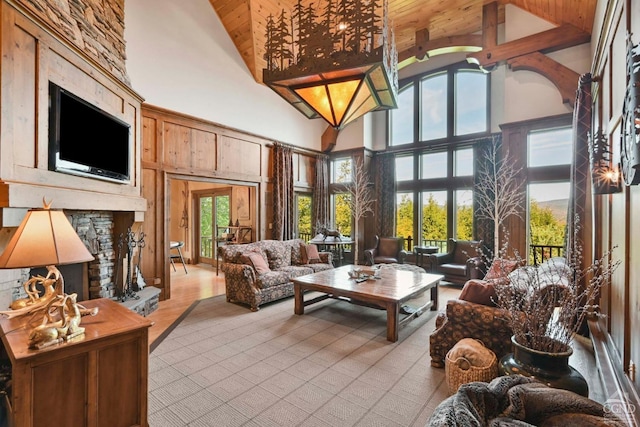 sunroom with a fireplace, vaulted ceiling with beams, and wood ceiling