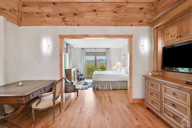 bedroom with light hardwood / wood-style floors, wood ceiling, and access to outside