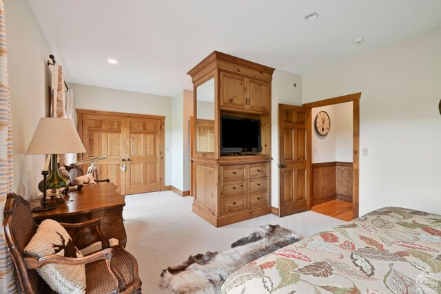 carpeted bedroom with wooden walls