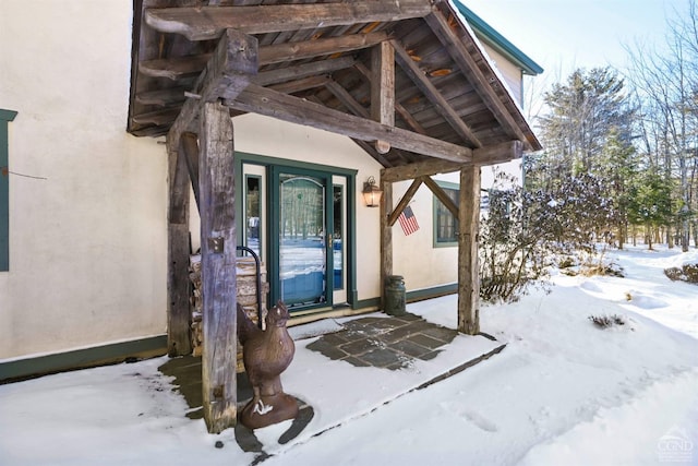 view of snow covered property entrance