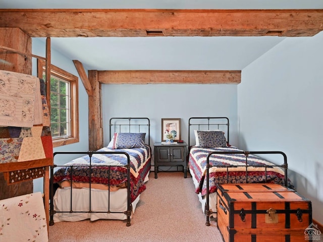 carpeted bedroom featuring beam ceiling