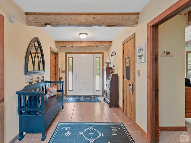 entrance foyer with beamed ceiling and tile patterned floors