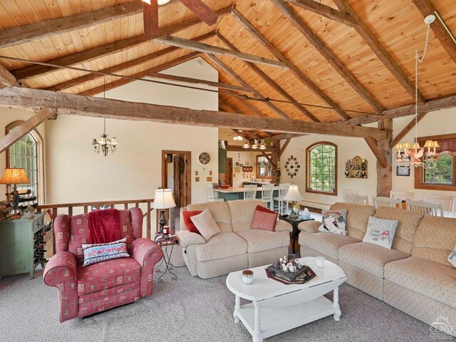 carpeted living room featuring ceiling fan, beam ceiling, high vaulted ceiling, a stone fireplace, and wooden ceiling