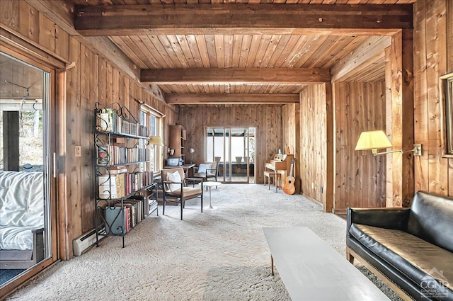 living area featuring wooden walls, baseboard heating, beam ceiling, carpet, and wood ceiling