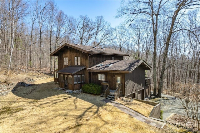 view of front of property featuring a wooded view