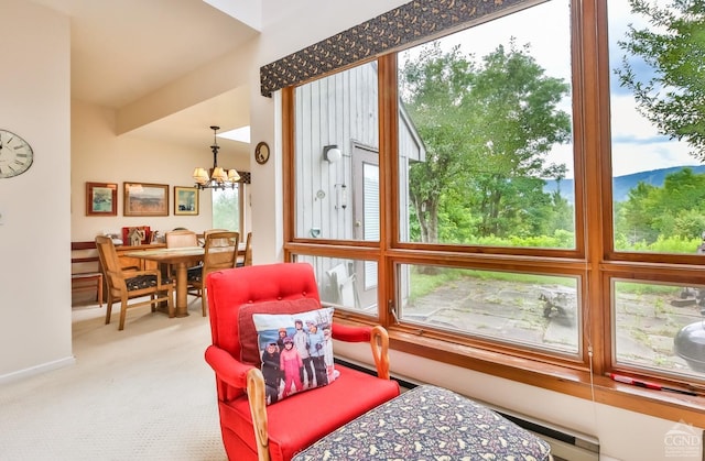 sunroom featuring a chandelier