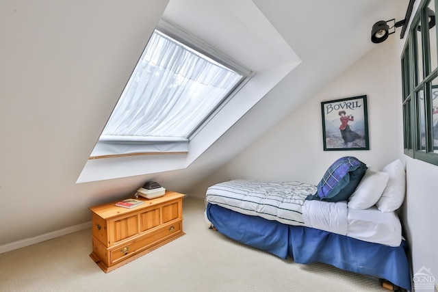 carpeted bedroom with lofted ceiling