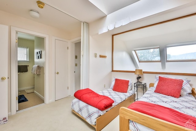 carpeted bedroom with a skylight