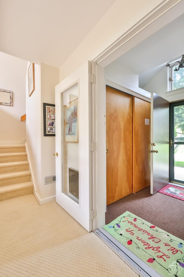 hallway featuring carpet and lofted ceiling