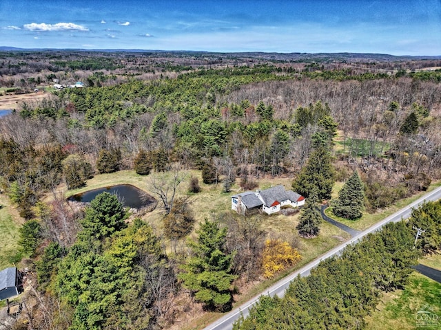 aerial view featuring a water view and a view of trees