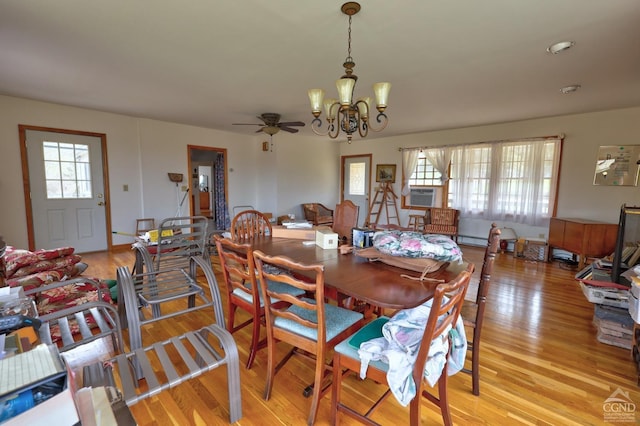 dining space with ceiling fan with notable chandelier and light wood-style floors