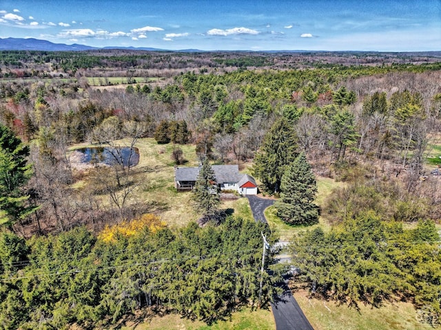 birds eye view of property featuring a view of trees