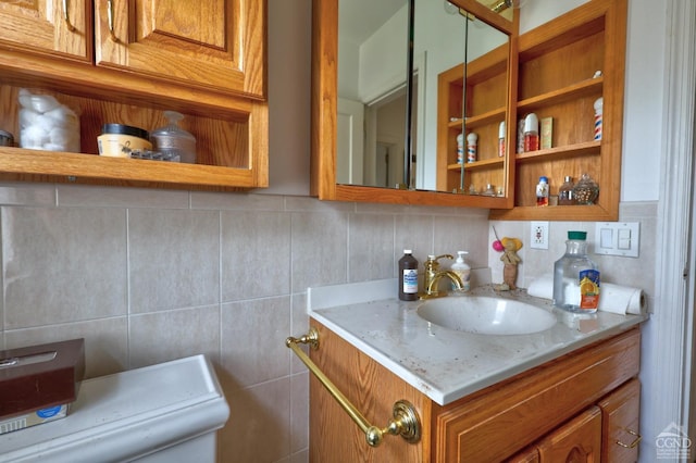 bathroom featuring tile walls, decorative backsplash, and vanity