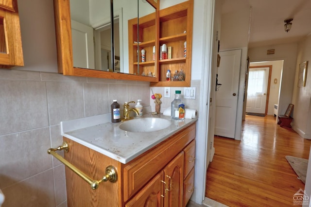 bathroom with vanity, tasteful backsplash, and wood finished floors