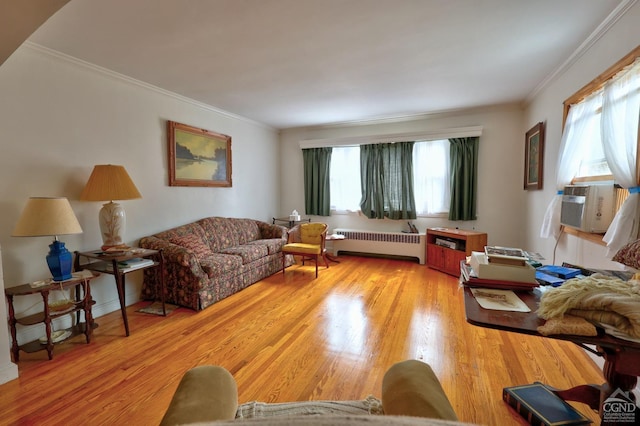 living room featuring radiator, ornamental molding, cooling unit, and wood finished floors