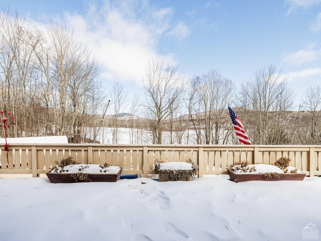 snowy yard featuring a wooden deck