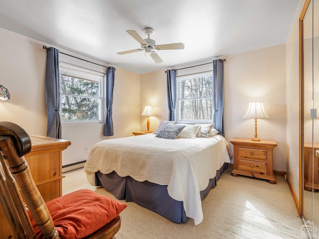 bedroom featuring baseboards, multiple windows, a baseboard heating unit, and a ceiling fan