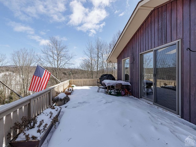 yard covered in snow with a wooden deck