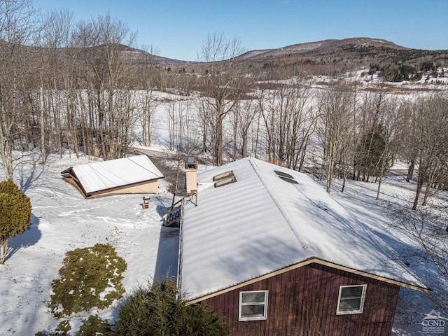 snowy aerial view featuring a mountain view