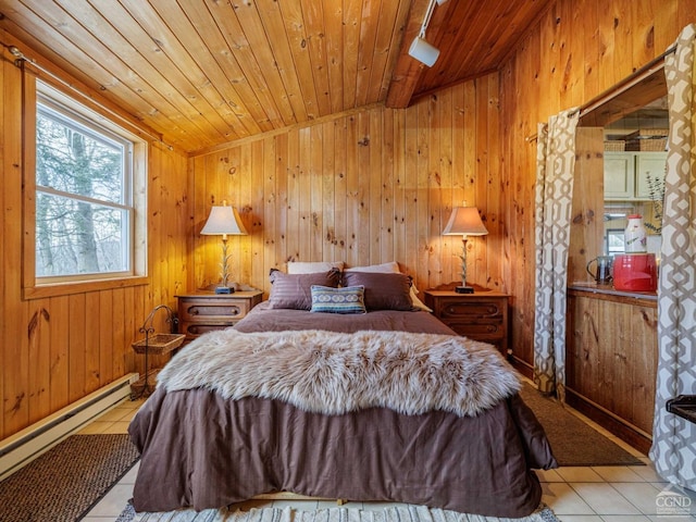 bedroom with light tile patterned floors, wood ceiling, wooden walls, and baseboard heating