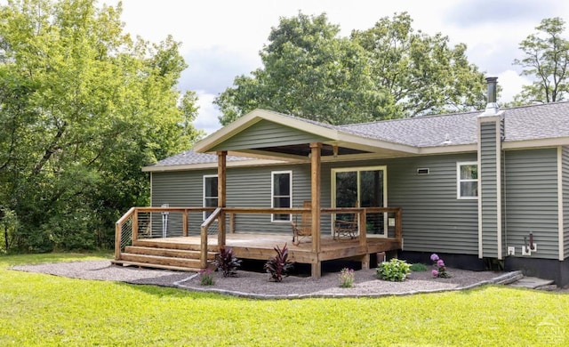 back of house featuring a wooden deck and a yard