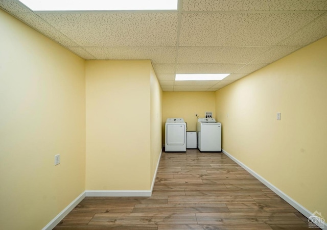 washroom featuring light hardwood / wood-style flooring and washing machine and clothes dryer