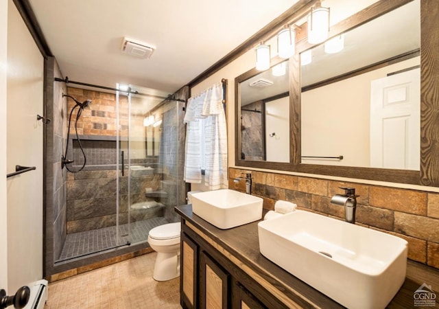 bathroom featuring vanity, decorative backsplash, toilet, walk in shower, and a baseboard radiator