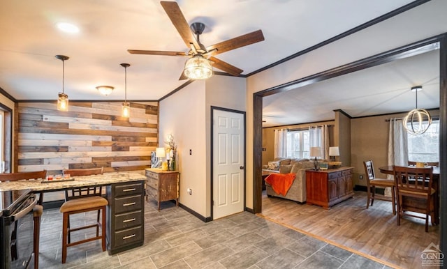 home office with ceiling fan, wood-type flooring, vaulted ceiling, and ornamental molding