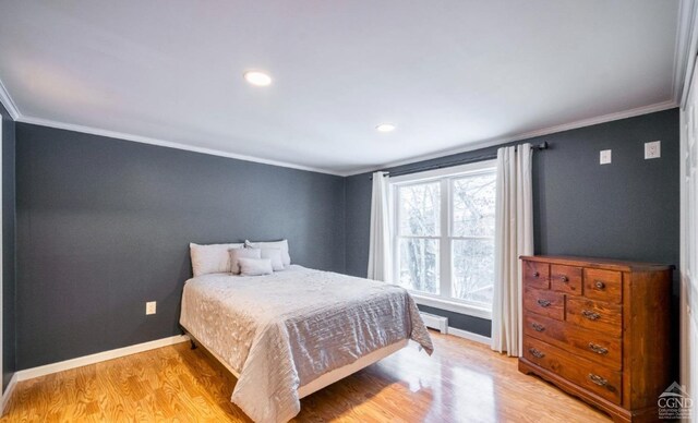 bedroom featuring light hardwood / wood-style flooring and ornamental molding