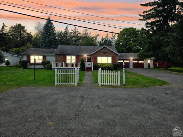 ranch-style house with a yard and a garage