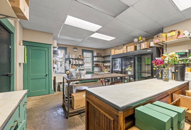 interior space with a paneled ceiling