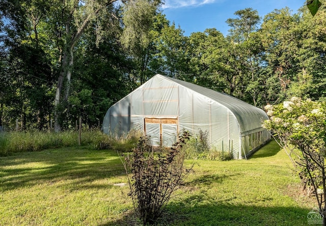 view of outbuilding featuring a yard