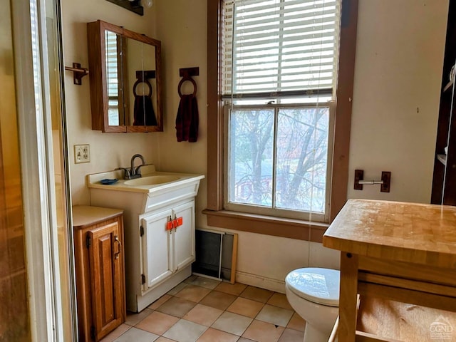 bathroom with tile patterned floors, vanity, and toilet