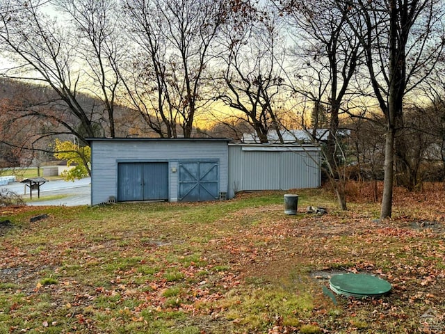 yard at dusk featuring a shed