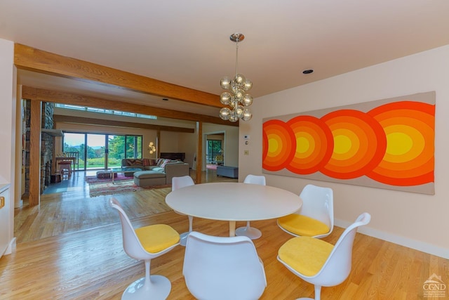 dining room featuring beamed ceiling, a notable chandelier, and light hardwood / wood-style floors