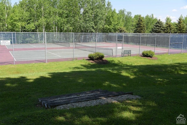 view of sport court with a yard