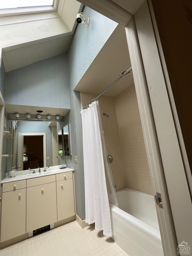 bathroom featuring tile patterned flooring, vanity, and shower / bathtub combination with curtain