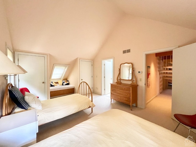 carpeted bedroom with a closet and high vaulted ceiling