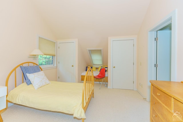 bedroom featuring lofted ceiling and light carpet