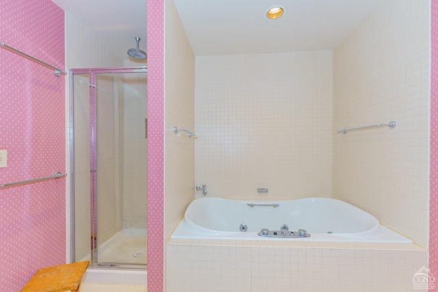 bathroom featuring shower with separate bathtub