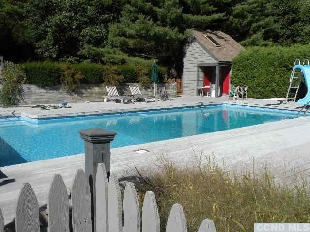 view of swimming pool featuring a patio area and a water slide