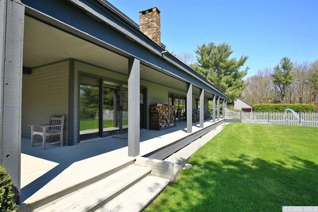 view of property exterior with a patio area and a yard