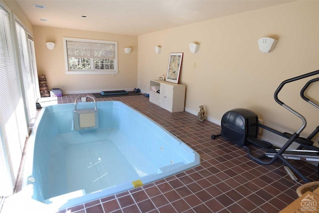 miscellaneous room with dark tile patterned floors