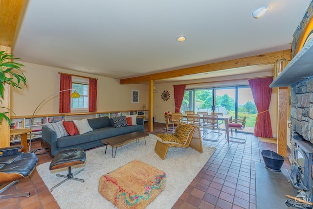 tiled living room with a stone fireplace