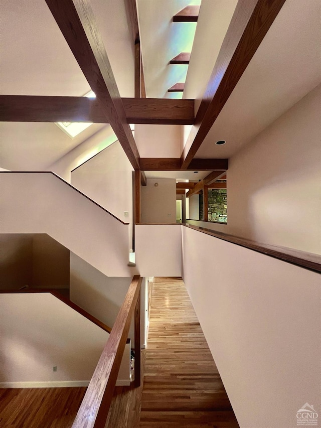 hall featuring hardwood / wood-style floors and beamed ceiling